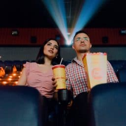 Woman and man at movie theater. Telecoil is often an option in public venues.