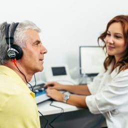 Senior man at medical examination or checkup in otolaryngologist's office