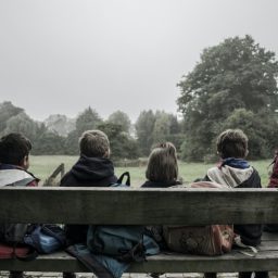 Children sitting together outside.