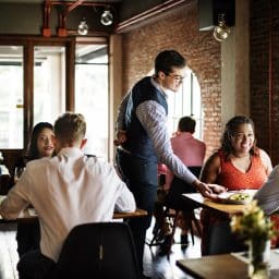 People dining at a busy restaurant.