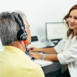 Audiologist administering a hearing test